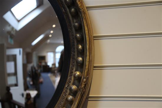 A large Regency circular gilt convex wall mirror, 4ft 10in. x 2ft 7.5in.